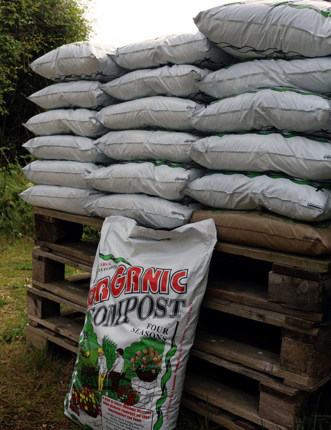 Bags of Four Seasons compost stacked at the yard, ready for collection